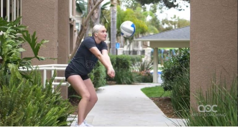 girl passing volleyball against wall